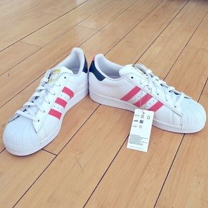 Adidas sneakers with pink and gold accents